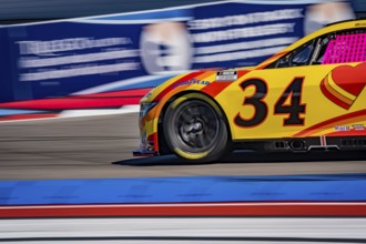 NASCAR Cup Series driver, MICHAEL MCDOWELL (34), races through the turns during a practice session
