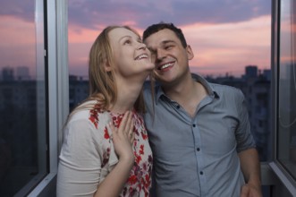 Playful young couple enjoying their new own apartment