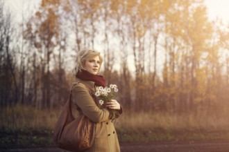 Young beautiful woman in the park in autumn season