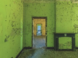 Dilapidated room with bright green wall colour and old fireplace, Prison H11, Lost Place, Verviers,