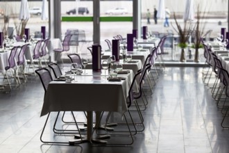Indoor restaurant tables ready for service. Small GRIP contrejour (against the light) shot