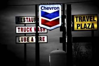 Barstow, United States - December 22, 2015: Brightly lit neon signs of various brands and