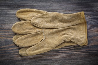 Pair of working gloves on vintage wooden board directly above agriculture concept