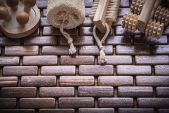 Wood peeling brush massagers and loofah on checked wooden place mat healthcare concept