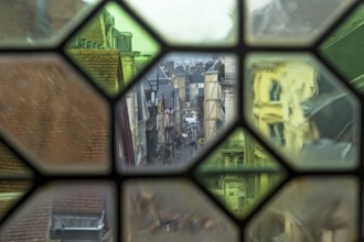 Rouen, France, August 30, 2018: View of the city street through the old window on the clock tower