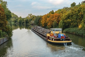 Transportation industry. Ship barge transports scrap metal and sand with gravel. Barge loaded with