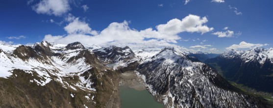Aerial view on Ritom lake between snow-capped mountains at spring, Switzerland alps, panorama