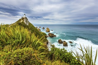 Nugget Point Lighthouse on the picturesque Cape Nugget. South Island, New Zealand. The coast of the