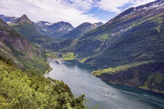 The largest, most beautiful and famous Norwegian fjord Geiranger. Snow-white ocean liner is moored