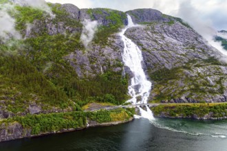 Langfossen is a magnificent cascading waterfal on the Vaule River. Passes through the highway.