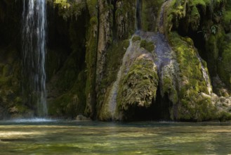 The tufa waterfall near Arbois. Crystal clear waterfall, powerful waterfall