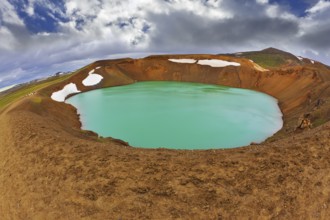 Krafla lake in the crater of an extinct volcano. Lake water bright green color. On the shores lie