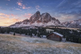 Passo Erbe under the mountain Peitlerkofel, or Sass de Putia before sunrise with wood hut