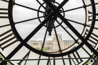 View of the Louvre through a large Clock from Museum d'Orsay in Paris, France, Europe