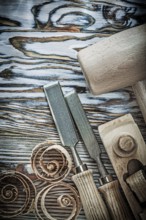 Wooden hammer chisels planer curled shavings on wood board