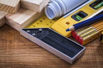 Square ruler pencil blueprints wooden meter and studs construction level on vintage wood board