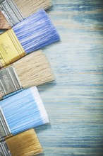 Set of paint brushes on wood board construction concept
