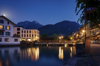 Tranquil night scene with reflections on a lake and mountains in the background, city, vilage,