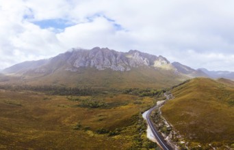 An aerial view of Gordon River Rd at the Sentinel range of mountains near Bitumen Bones Sculpture