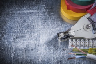 Electrician's set on scratched metallic background copy space electricity concept