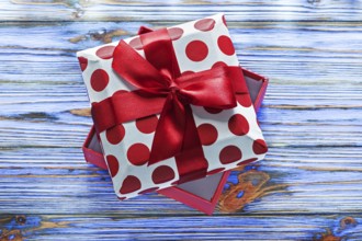 Opened wrapped present box on vintage wooden board
