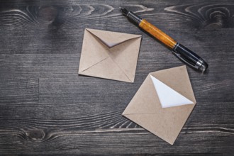Vintage envelopes fountain pen on wooden board