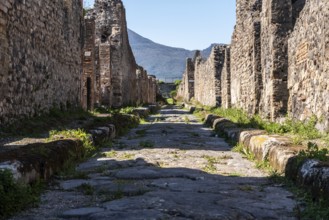 POMPEII, ITALY, MAY 04, 2022, A beautiful typical cobbled street in the ancient city of Pompeii,