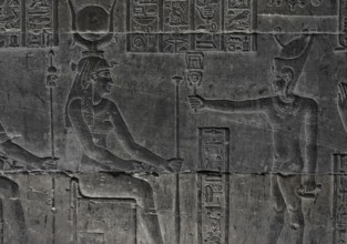 Hieroglyphic carvings on the wall of an ancient egyptian temple