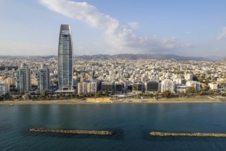 Drone aerial view of waterfront of modern coastal city with skyscrapers. Limassol town Cyprus