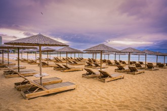 The beach has sunbeds and bamboo parasols and appears quiet and deserted when the sky is cloudy,