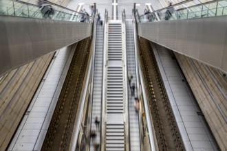 Escalator leads with motion blur through modern glass architecture, Leipzig Central Station