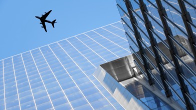 An image of a plane flying over modern buildings of New York City
