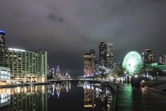 MELBOURNE, AUSTRALIA - JULY 5, 2024: Polly Woodside Park and ferris wheel and Melbourne skyline as