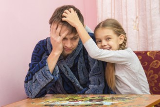 Daughter fun soothes tired dad who collect puzzles