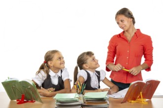Girls at their desks have fun watching their beloved teacher
