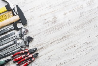 Variety of repair tools on wooden surface