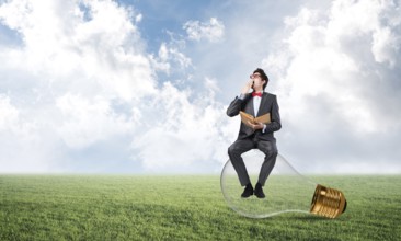 Young businessman with a book. Concept of Creativity in Business