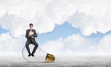 Young businessman with a book. Concept of Creativity in Business