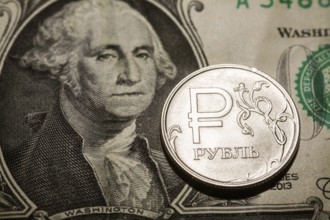 One ruble coin on dollar banknote. Closeup, macro shot