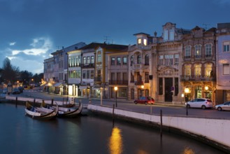 Moliceiro boats docked and Art Nouveau style buildings, Aveiro, Portugal, Europe