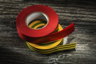 Set of insulating tapes on wooden board