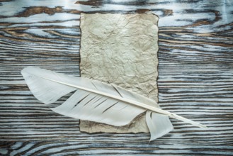Vintage paper quill on wooden board top view