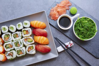 Sushi Maki and Niguiri California roll with seaweed chuka salad soy sauce and wasabi