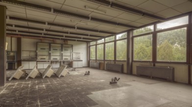 A dilapidated room with broken furniture and windows through which daylight shines, Institute of
