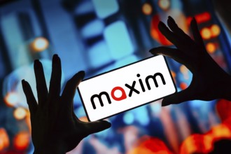 In this photo illustration, the Maxim logo is displayed on a smartphone screen