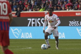 Football match, Amadou HAIDARA RB Leipzig concentrating on the ball looking to the left,