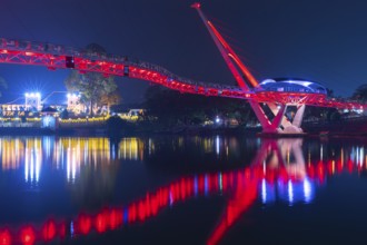 The Bridge of Kuching on Borneo illuminated in the evening