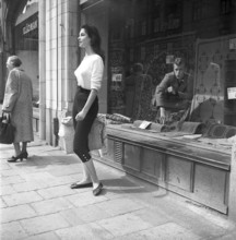 Young woman in 1956. She is standing in front of a shop window on Strandvägen in Stockholm and