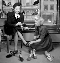 Shoe store in the 1940s. A woman in the shoestore on Hamngatan Stockholm 1948. She seems to look