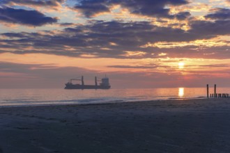 Sunset at the Seaside with a large ship and beautiful light and light reflections on the water